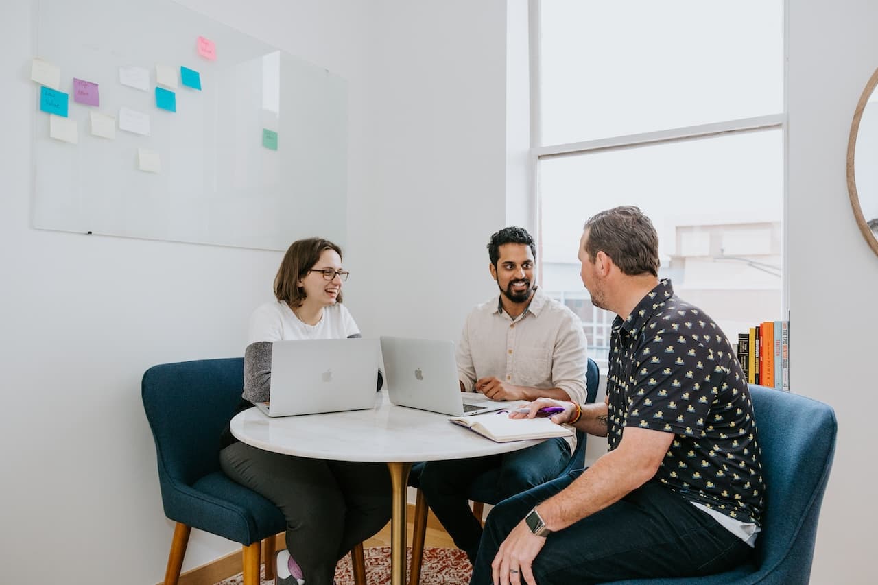 Image of employees sitting in around a table for a listening group.