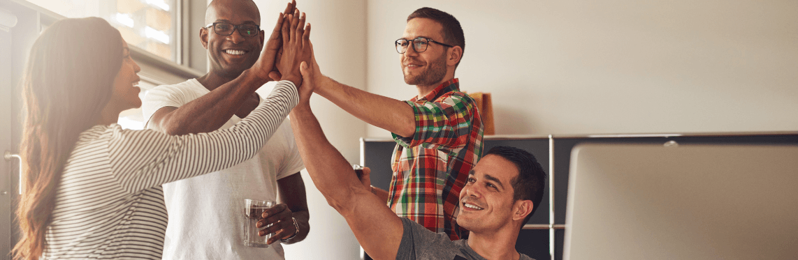 Featured image for benefits of diversity with employees high-fiving.