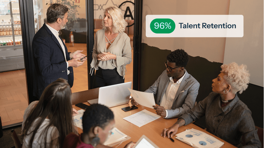 A team discussing talent retention strategies in a modern office setting.
