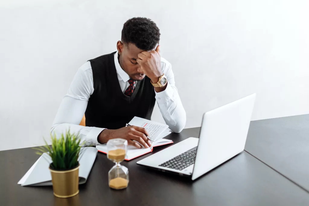 Man reading at a computer for online group mentoring. 