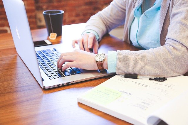 Woman typing on computer for mentoring relationships.