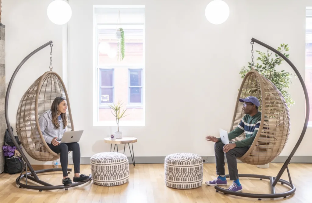 Knowledge sharing happening at the MentorcliQ office with hammock chairs.