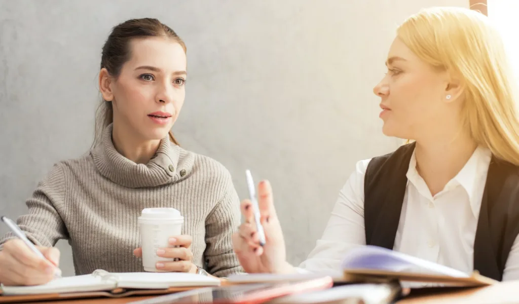 Women chatting using soft skills while mentoring.