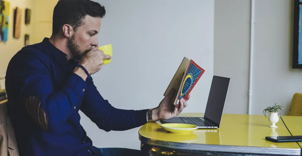 Reading books at a computer for mentoring program.