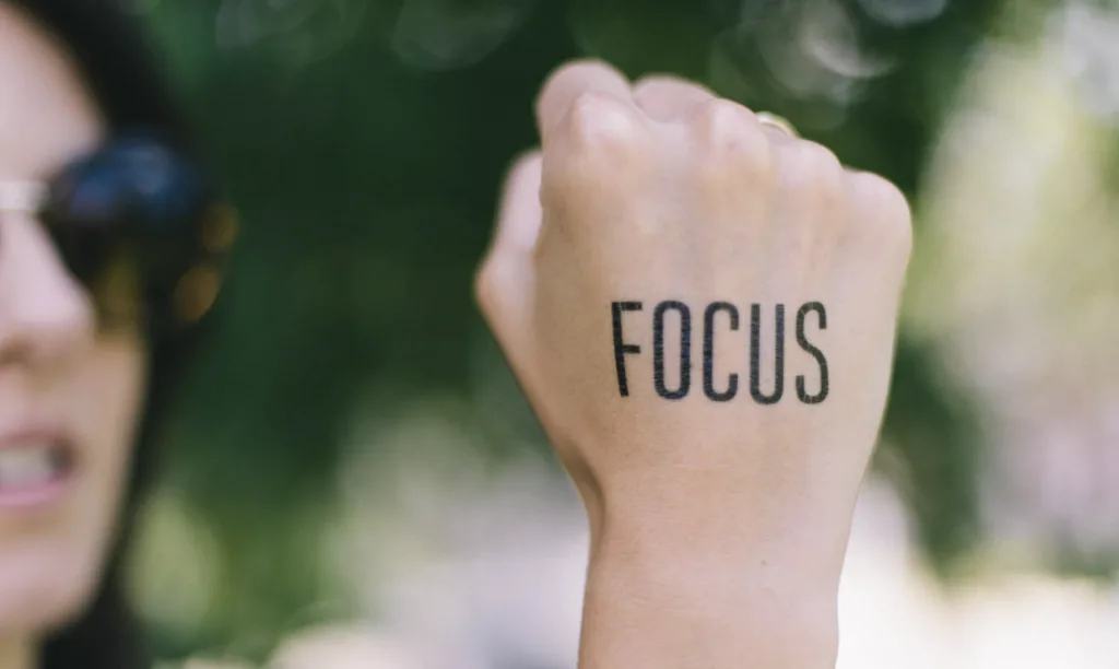Focus written on a hand to highlight long term career goals and motivation.