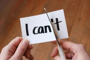 A Person cutting a piece of paper to say I can instead of I can't.