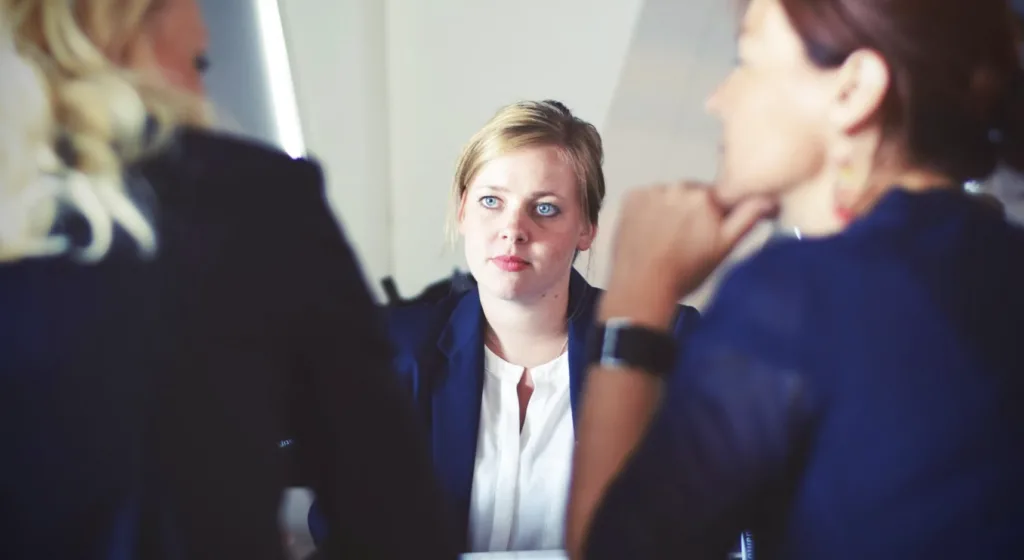 What Is the Purpose of Mentoring Programs? 5 Women on a job interview during employee engagement crisis.