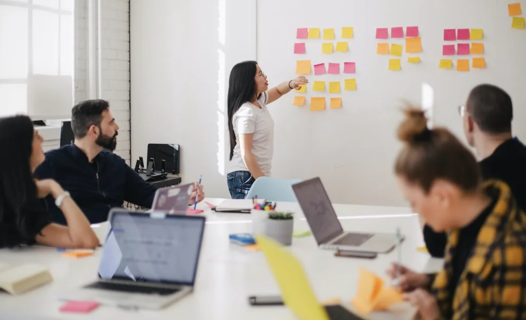 A meeting at an office where co-workers are discussing strategies and plans.