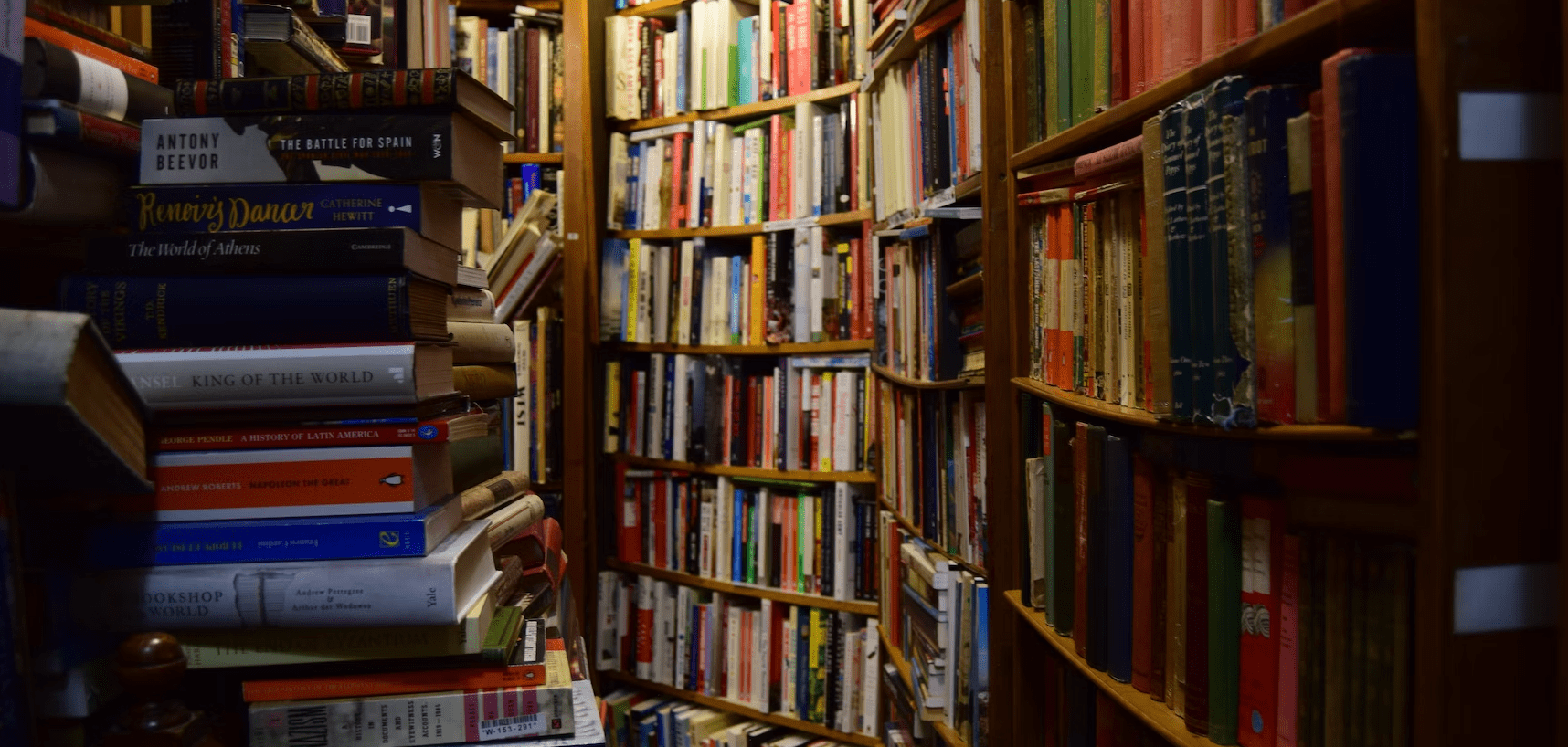 Hundreds of books on a book shelves.