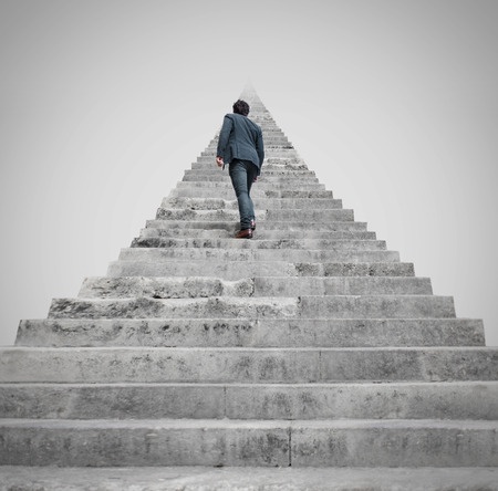 a person looking up a long stairway and getting facing to a challenge.