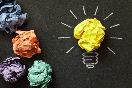 Inspiration concept crumpled paper light bulb metaphor for choosing the best idea