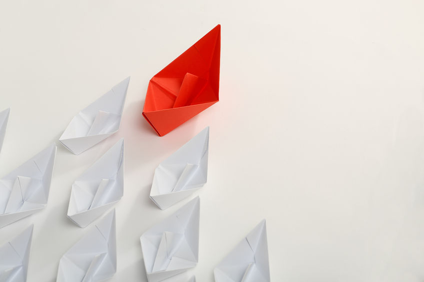red paper boat leading white ones, leadership concept