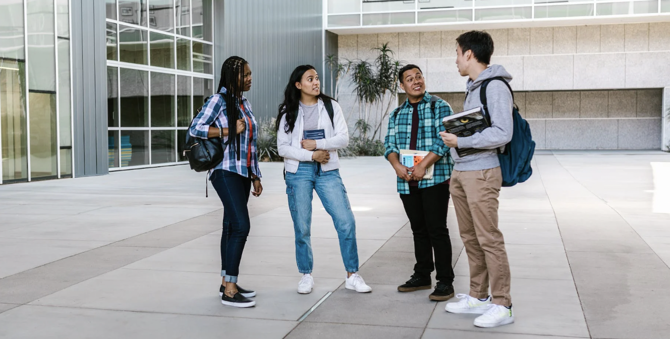 First-gen college students standing and talking.