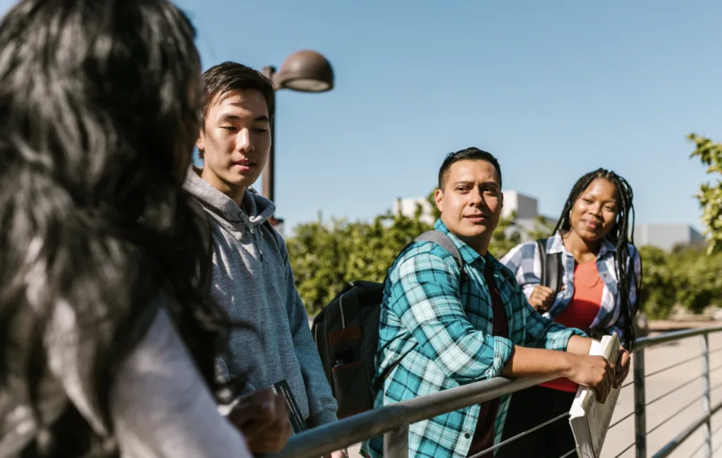 Remembering First-Gen College Students During National Mentoring Month 3 First-gen college students standing on path and talking.