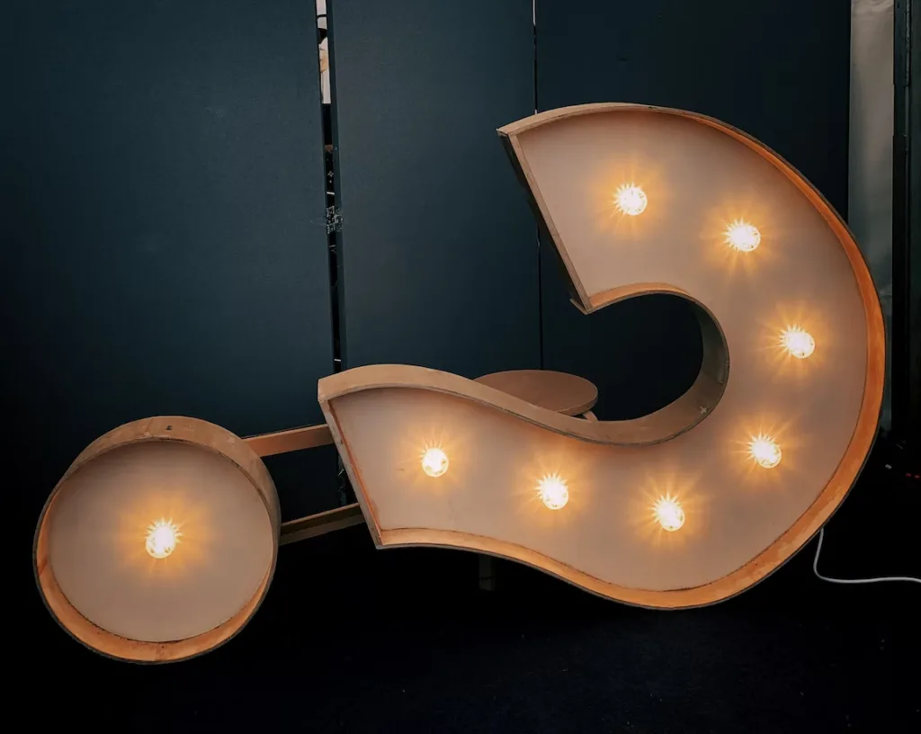 Light up question mark sign laying on it's side