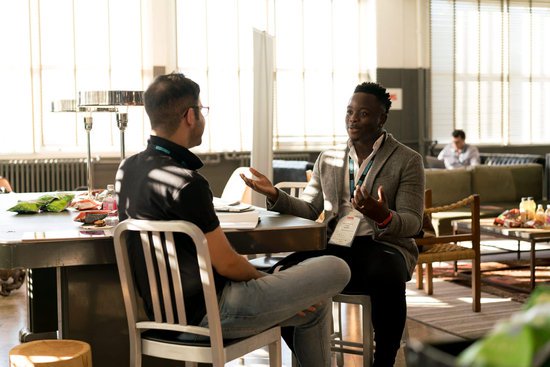 7 Types of Mentors: Which Mentor Is Right for You? 5 Two successful professional people at in a casual office setting discussing reverse mentoring.
