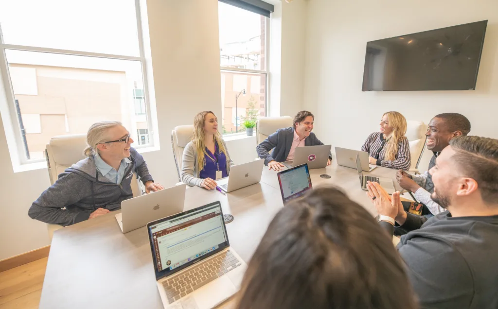 Team meeting in a conference room with an inclusive culture represented by men and women of different backgrounds.