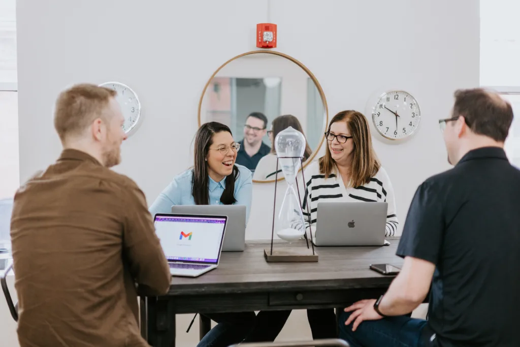 A group of working together within a frontend mentor program to upsill at a table.