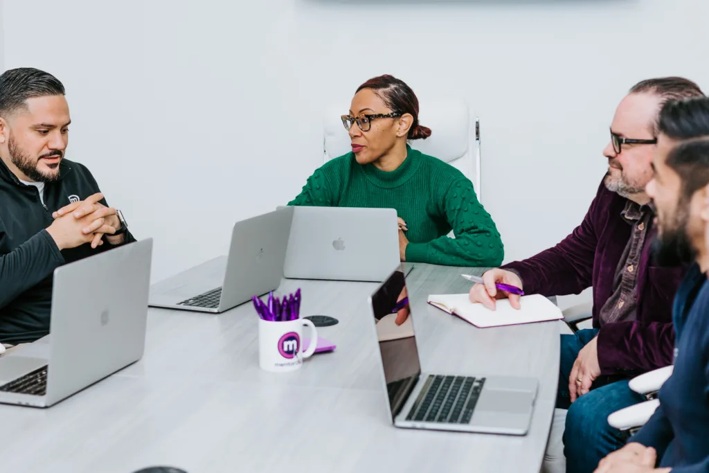 A mentoring example of employees in a meeting room talking about leadership