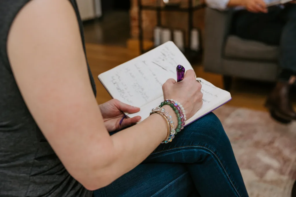 Woman writing in a journal about her career aspirations.