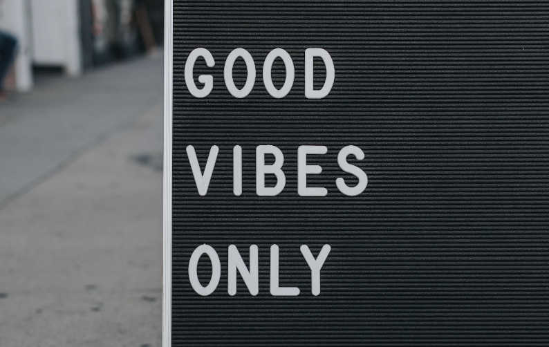 An image for occupational wellness showing "good vibes only" sign.